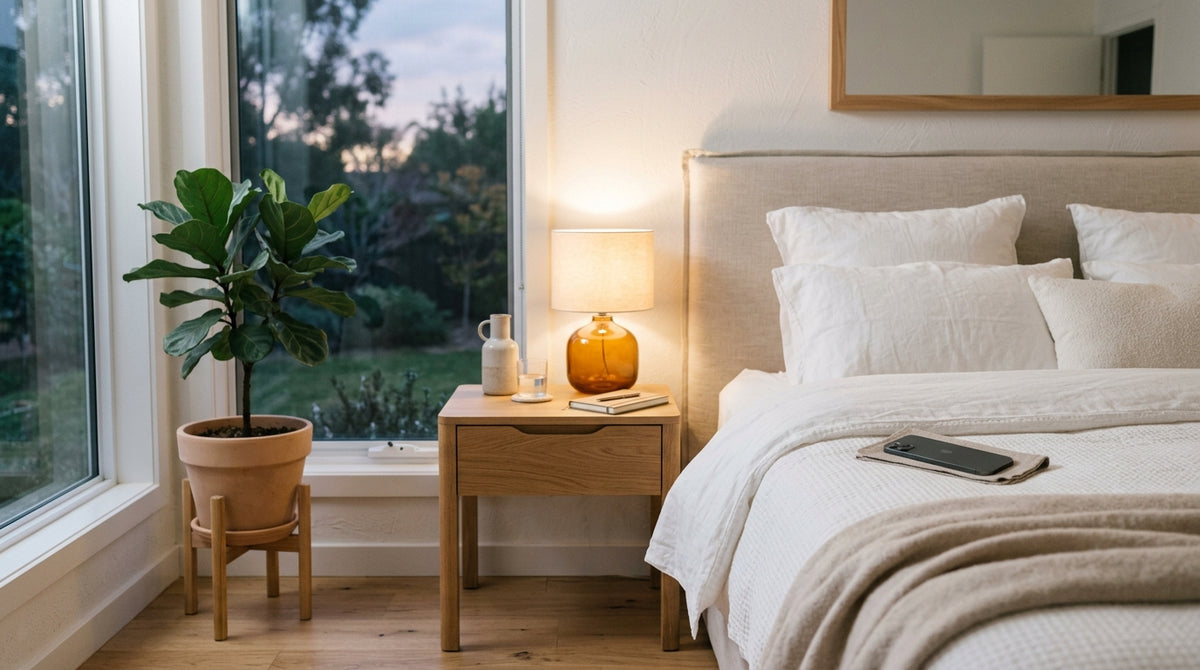 Peaceful bedroom scene with phone face-down on nightstand at dusk