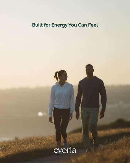 Active couple walking coastal path at sunrise promoting Evoria Morning Boost energy supplement