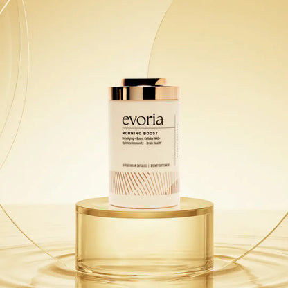 Evoria Morning Boost NAD+ supplement bottle with rose gold cap on gold pedestal