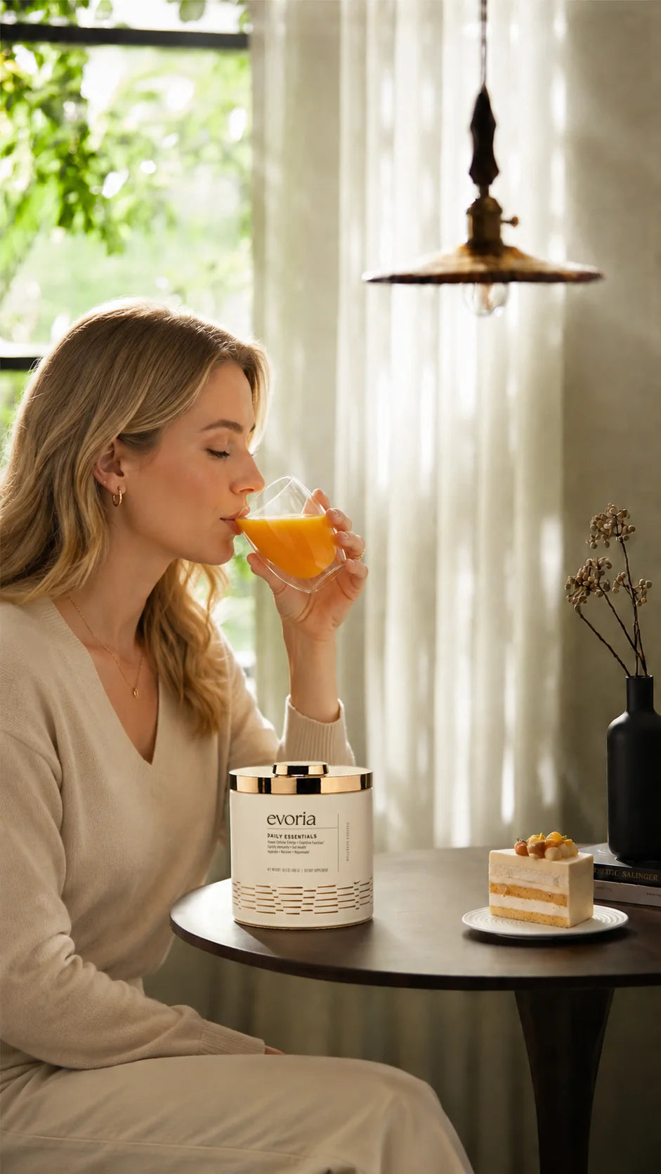 Woman enjoying Evoria Daily Essentials drink as part of her daily wellness routine
